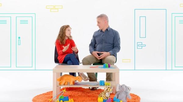 Daughter and dad sitting in chairs talking about changes at school.