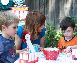 Parent with children coloring together at Daniel Tiger birthday party.
