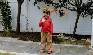 Child dressed as Daniel Tiger.