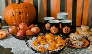 Party table with decorations and food.