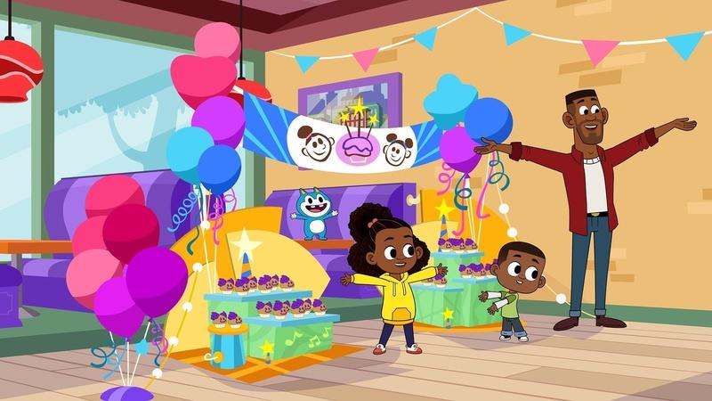 Lyla and her family standing in a room decorated for a birthday party.