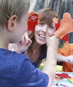 Child and parent playing with Daniel Tiger finger puppets at Daniel Tiger birthday party