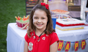 Child at Odd Squad birthday party wearing Odd Squad agent badge