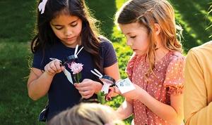 Kids holding magnifying glass party favors.