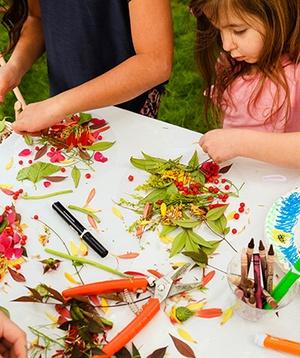 Kids making suncatchers from flowers.