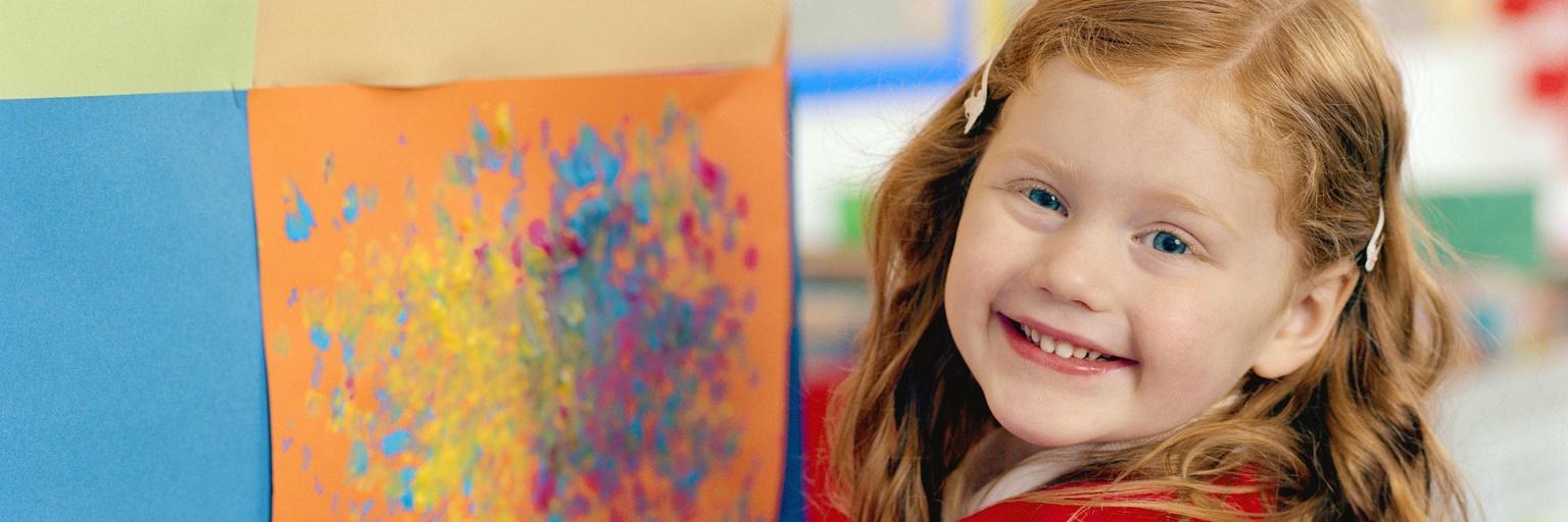 Image of five-year-old girl showing her painting.