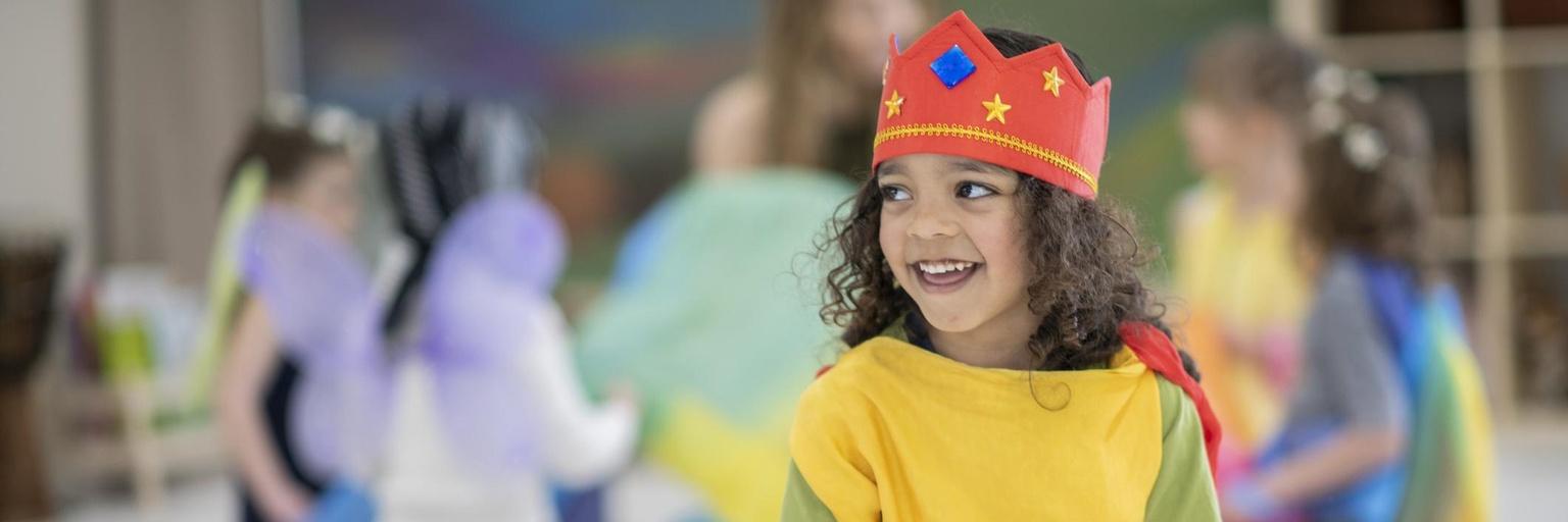Image of boy playing dress up.