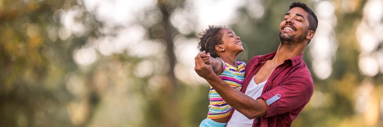 Image of father and daughter dancing together.