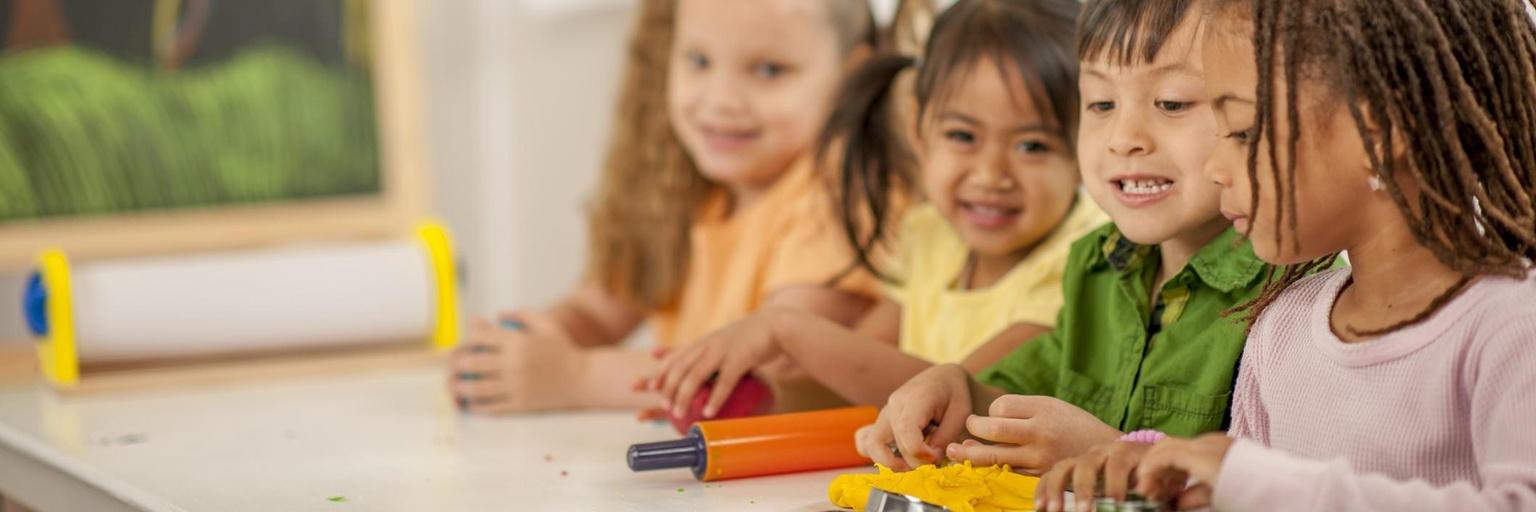 Image of preschoolers playing with playdough.