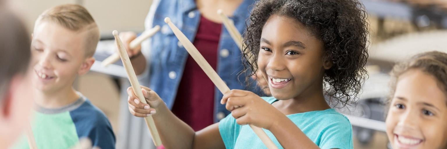 Image of girl playing drums.