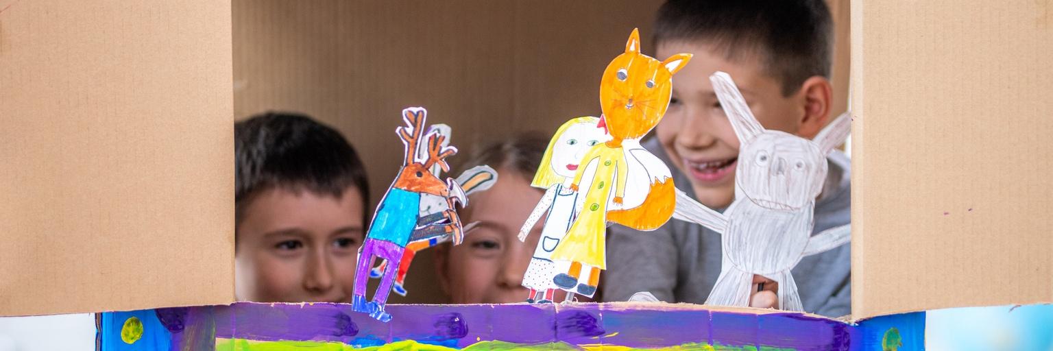 Image of kids putting on a puppet show.