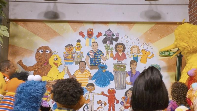 Episodic image of Sesame Street characters looking at mural.
