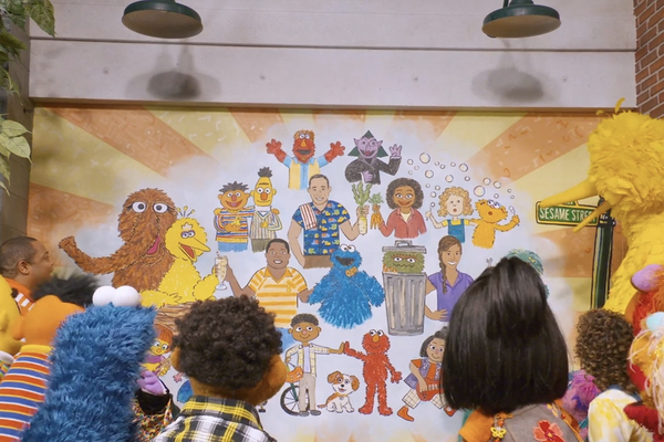 Episodic image of Sesame Street characters looking at mural.