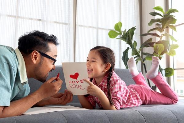 Father and daughter drawing appreciation cards together.