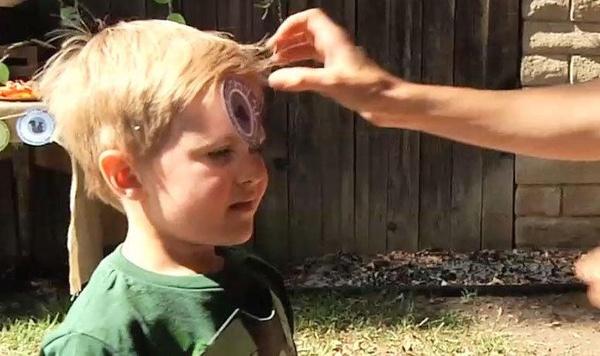 Adult placing a Creature Power Disc on a child's head.