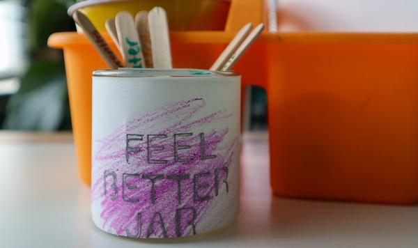 Image of a jar with the words "Feel Better Jar" and popsicle sticks with ideas for how to feel better.