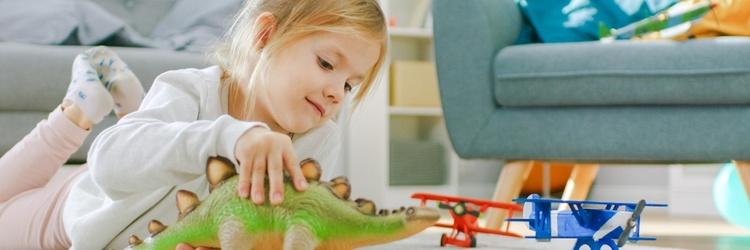 Image of child playing with dinosaurs.