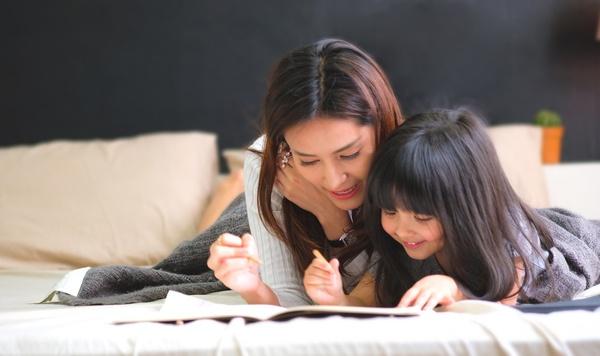 Image of mother and daughter reading together.