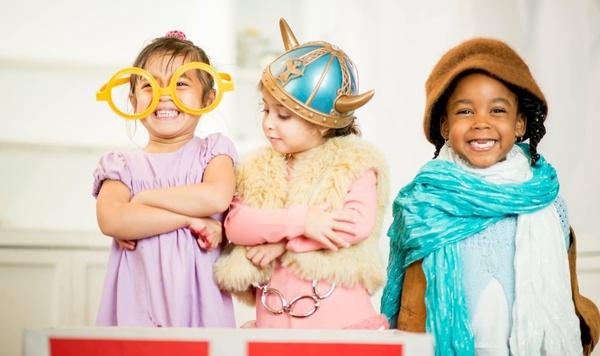 Three kids playing dress up.