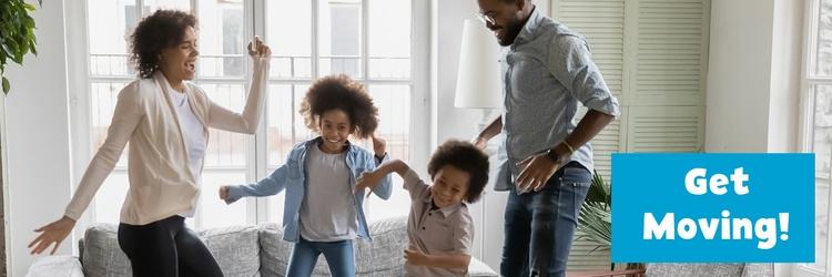 Family dancing together in their living room.