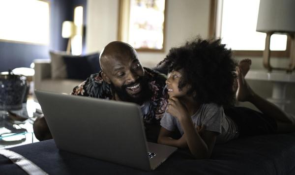 Father and son looking at a laptop.