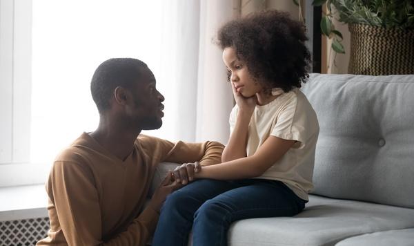 Image of father comforting his preschool daughter.