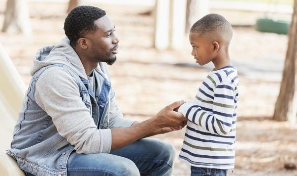 Father talking to son.