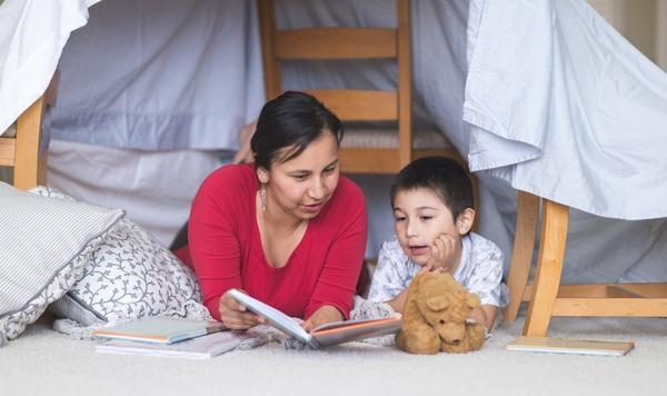 Image of mother and son reading a book together.