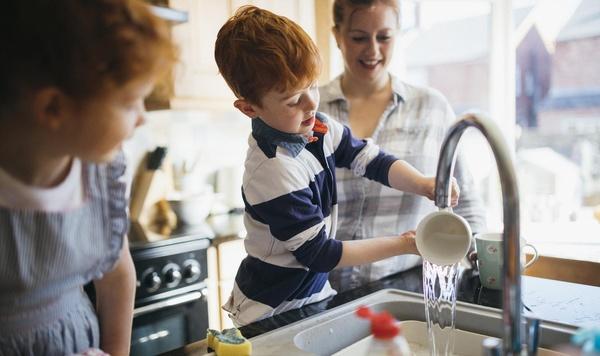 Image of boy and girl helping their mom with the dishes.