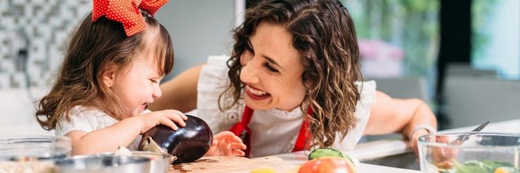 Mom and daughter cooking together.