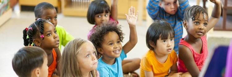 Children raising their hands.