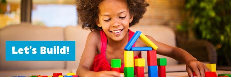 Little girl building with blocks.