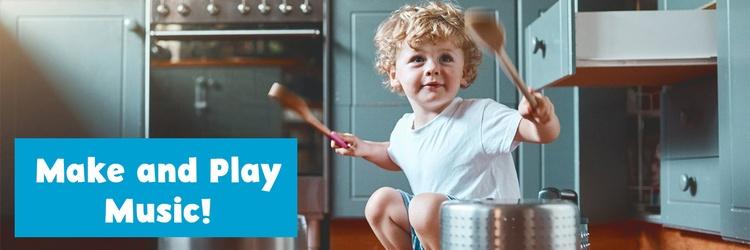 Image of young boy playing drums on pots and pans.