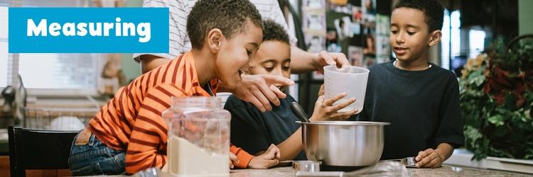 Father and sons cooking together.