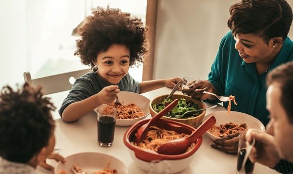 Family eating a meal together at the table.