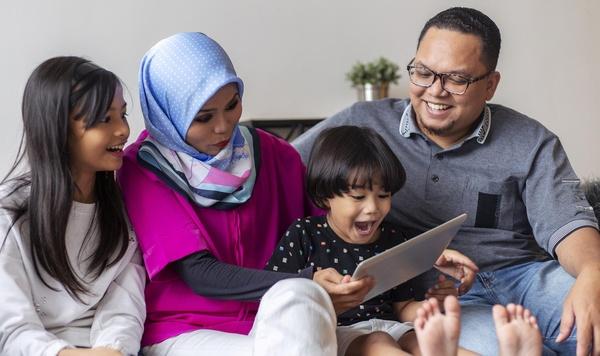 Family playing on a tablet together.