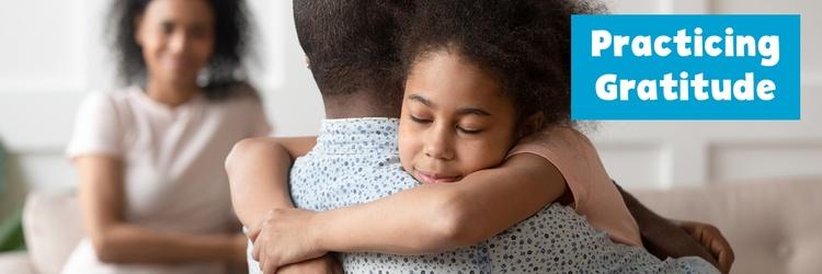 Dad and daughter hugging.