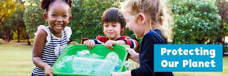 Three children practice recycling.