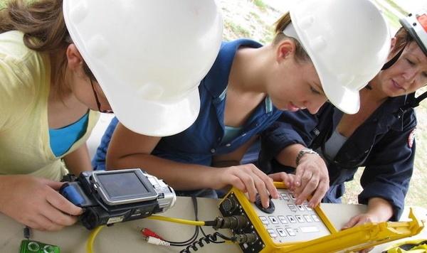 Image of girls programming a robot.