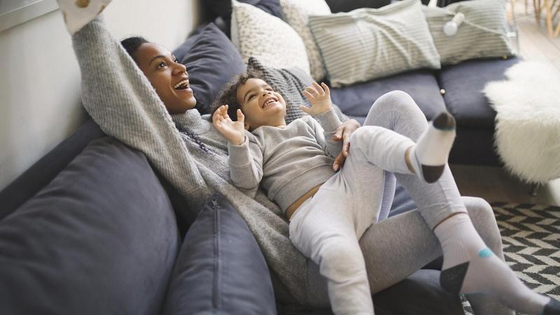 Mother and son playing on the couch.