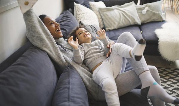 Mother and son playing on the couch.
