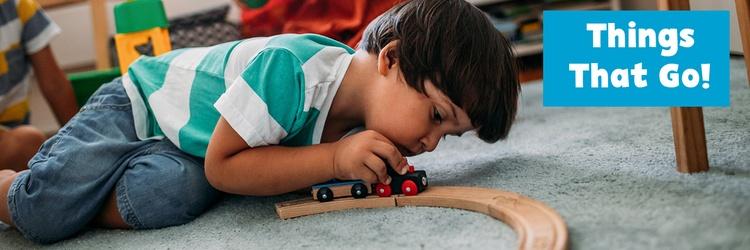 Little boy playing with a toy train.